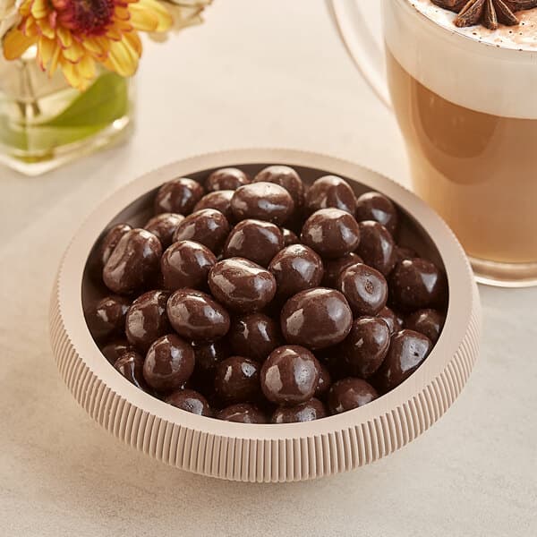 A bowl of dark chocolate covered espresso beans.